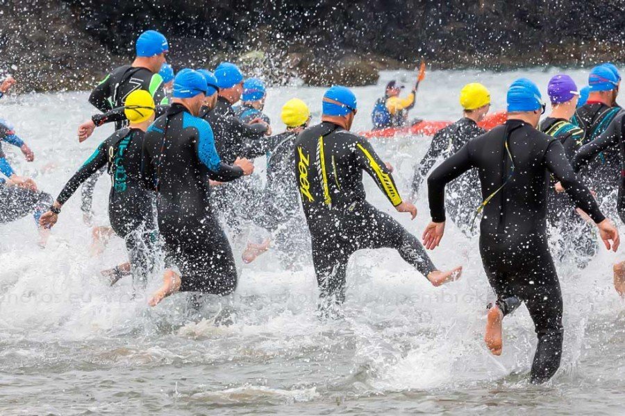 Triathlon competitors enter the water at broad haven 